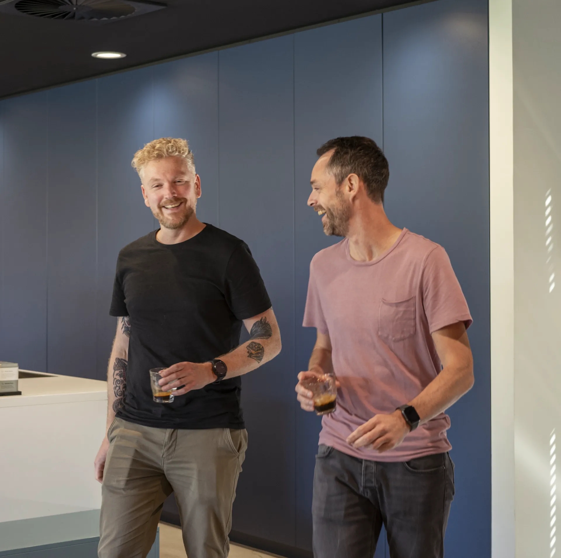 Guys working and chatting in the office